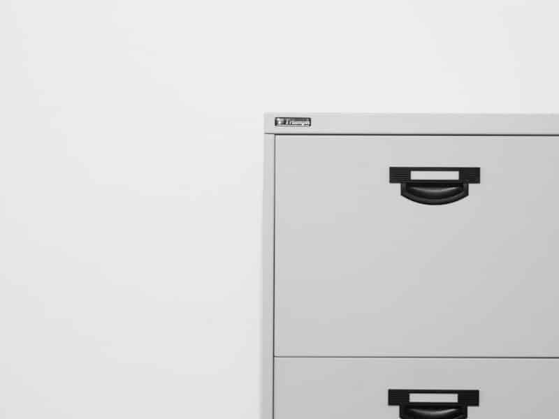 gray metal filing cabinet on white surface
